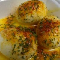 Garlic Eggs · Three boiled eggs with garlic seasoning and garlic butter.