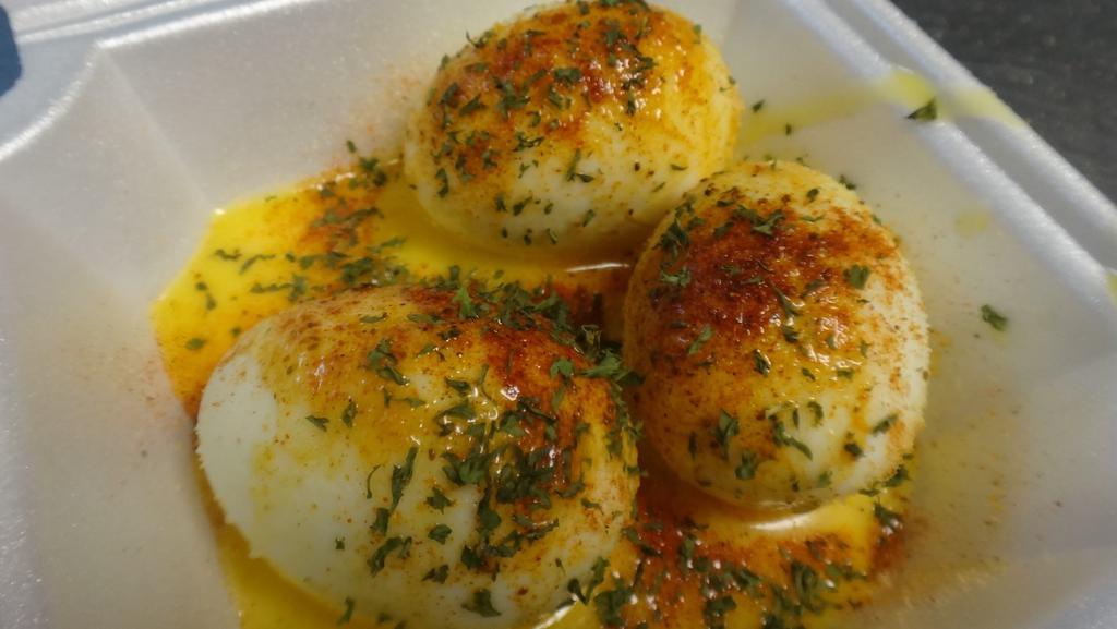 Garlic Eggs · Three boiled eggs with garlic seasoning and garlic butter.
