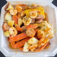 Garlic Snow Crab N Shrimp Combo · Two Snow crab clusters, one corn, 10 shrimp, sausage, pork sausage topped with our delicious...