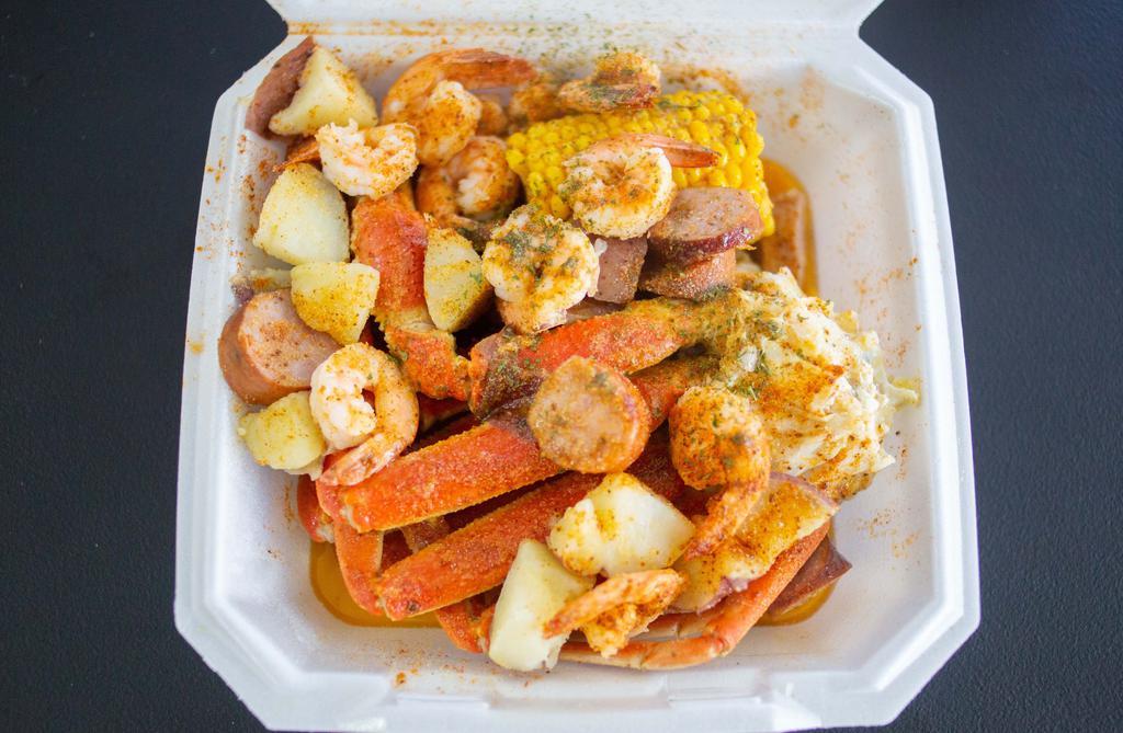 Garlic Snow Crab N Shrimp Combo · Two Snow crab clusters, one corn, 10 shrimp, sausage, pork sausage topped with our delicious garlic butter, garlic seasoning, old bay, and parsley.