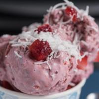 Tropical Turbine Ice Cream · Coconut and black raspberry ice cream with mixed berries and coconut flakes in a waffle bowl