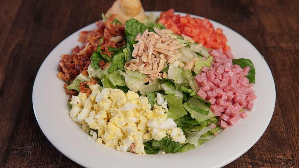 Large Tavern Salad · Iceberg and Romaine Mix, Tomatoes, Eggs, Ham, Bacon, and Almonds.
