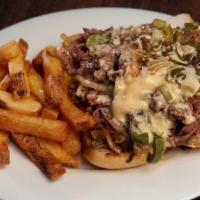 *Philly Cheesesteak · Thinly Shaved Ribeye, Grilled Peppers, Onions & Provolone on a Hoagie Roll