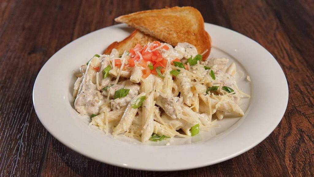 Chicken Penne Pasta · Herb roasted chicken, penne pasta, classic alfredo sauce, topped with fresh tomato, parmesan cheese, and green onions