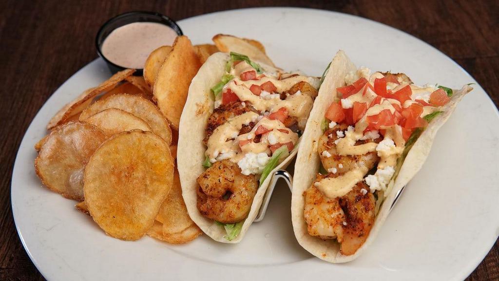 Spicy Shrimp Tacos · Two Tacos filled with Blackened Shrimp, Shredded Lettuce, Queso Fresco and Tomato. Topped with Fresh Cilantro