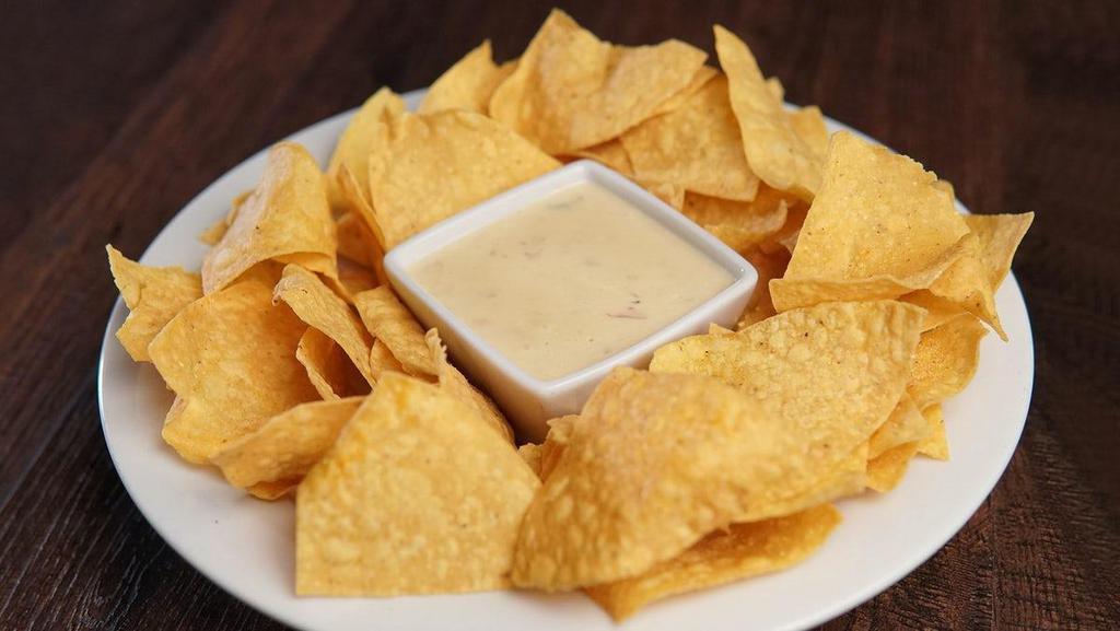 Queso & Chips · Our Tavern Signature Queso Dip, served with Tortilla Chips