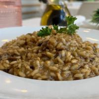 Vegan Mushroom Porcini Risotto · Carnaroli Rice with porcini mushroom, white wine, and vegan butter.