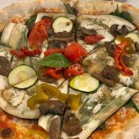 Vegan Pizza Ortolana · Tomato sauce, vegan mozzarella cheese, eggplant, baby squash, spinach, and red pepper.