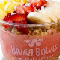 Summer Breeze Bowl · Pineapple, strawberries, banana, orange juice, granola, coconut shavings, and honey.