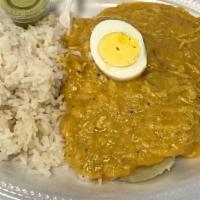 Aji De Gallina · Pulled boiled chicken breast in a creamy yellow sauce, served with boiled potato slices and ...
