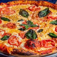 Margherita Pizza · Fresh crushed tomatoes, fresh mozzarella, fresh basil and olive oil.
