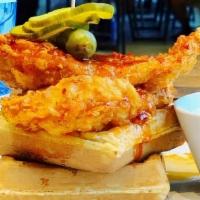 Nashville Hot Chicken & Waffles · crispy fried chicken breast tossed in sriracha infused chili oil and served
with waffles; ex...