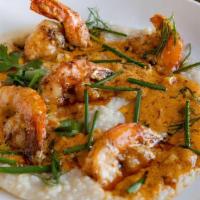 Shrimp & Grits · pan seared garlic buttered gulf shrimp smothered in a cajun style
cream sauce over grits ser...