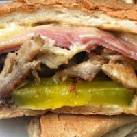 El Cubano Sandwich · Deli pork, ham, Swiss cheese, mayo, pickles on a roll.