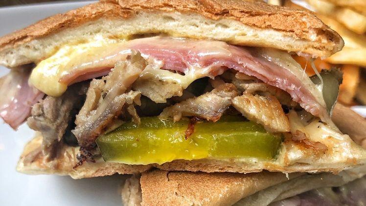 El Cubano Sandwich · Deli pork, ham, Swiss cheese, mayo, pickles on a roll.