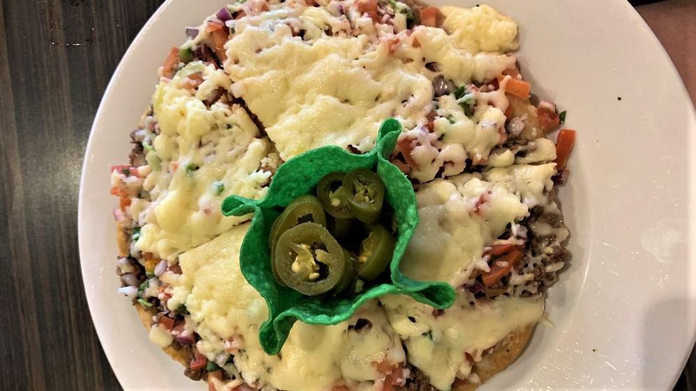 Pizza Mexicana · Crispy flour tortilla sliced and topped with Mexi-beans, delicious ground beef or our tasty pulled chicken, with melted cheese, pico de gallo, and jalapeños.