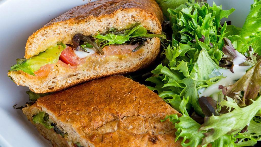 Salmon Baguette Sandwich Combo · Sliced Nordic smoked salmon, vine-ripened tomatoes, baby greens, hard-boiled eggs, and fresh aioli served on our whole wheat baguette and drink.