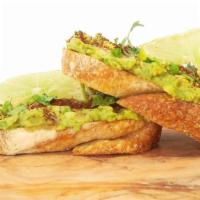 Avocado Toast · Creamy guacamole with chopped red onions, tomato, and lime juice, topped with cilantro and c...