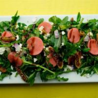 No Fig Deal Salad · Baby arugula and red onion tossed in lemon infused EVOO. Topped with goat cheese, figs, pick...