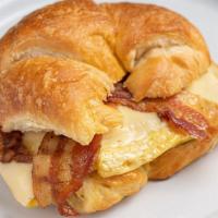 Breakfast Croissant · Scrambled eggs with white American Cheese and Bacon OR Ham on a fresh baked croisssant