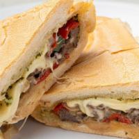 Cuban Philly Sandwich · Thin slices of Skirt Steak, grilled onions & peppers, melted Swiss cheese topped with Chimic...