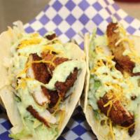 Tacos - Schnitzel · (2) warm flour tortillas filled with fried pork chop slices on a bed of shredded lettuce, to...