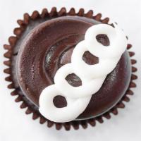 Chocolate Cream Cupcake · Chocolate cake, filled with white buttercream, frosted with fudge icing, and garnished with ...