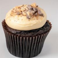 Peanut Butter Cup Cupcake · Chocolate cake, frosted with peanut butter cream cheese, and garnished with peanut butter sa...