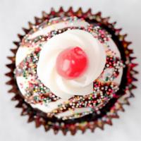 Hot Fudge Sundae Cupcake · Chocolate cake, filled with fudge royale, frosted with white buttercream, and garnished with...