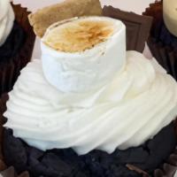 S'Mores · Chocolate cake with buttercream icing. Garnished with a marshmallow, fudge, graham cracker a...