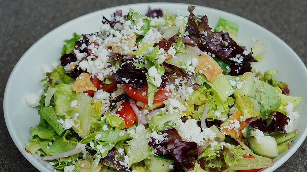 Greek Salad · mixed greens, cucumbers, tomatoes, red onion, olives, feta, seasoned pita crisps, greek dressing