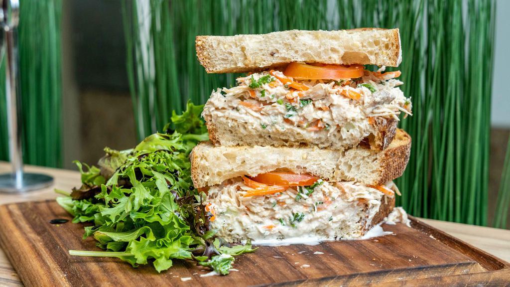Thunnus · Tuna mayo salad sandwich with carrot on a multigrain bread and a mix green salad.