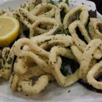 Calamari Fritti · Fried calamari served with marinara, greens and lemon.