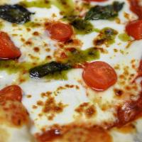 Caprese Pizza · Tomato sauce, fresh mozzarella, tomato slices basil, and pesto oil.