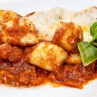 Gnocchi Sorrentina · Handmade gnocchi with mozzarella, basil, and  tomato sauce.