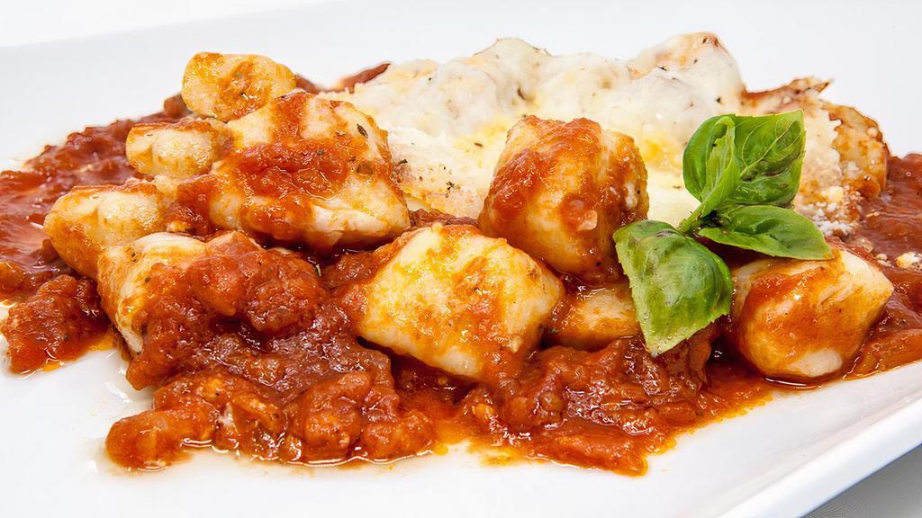 Gnocchi Sorrentina · Handmade gnocchi with mozzarella, basil, and  tomato sauce.