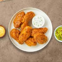 Mango In The Night Habanero Wings · Fresh chicken wings fried until golden brown, and tossed in mango habanero sauce. Served wit...
