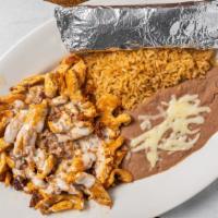 Choripollo · A tasty combination of chicken, chorizo and cheese dip. served with rice and beans