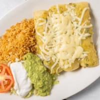 Enchiladas Suizas · Three chicken enchiladas topped with green sauce, lettuce, tomatoes and sour cream, with gua...