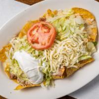 Nachos Supreme · Chicken, beef, bean and cheese nachos, all covered with lettuce, tomatoes. sour cream and sh...