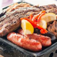 Parrillada Para Dos ·  Mixed Grill For Two · Skirt Steak, Short Ribs, 2 Chorizos, Morcilla, Mollejas and Chicken. Served with two sides.