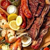 Parrilada Mar Y Tierra · Land & Sea Grill · short ribs, skirt steak, chorizo,  shrimp, prawns calamaris, mussels & clams; served with tw...