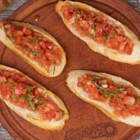 Bruschetta · Vine-ripened tomatoes, fresh garden basil, garlic and olive oil on three toasted baguette sl...