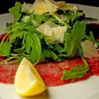 Carpaccio Di Manzo · Thinly slices of raw beef, served with mixed greens, shaved parmesan lemon & olive oil