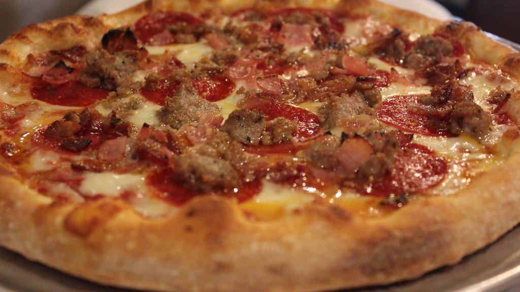 Carne Pizza · Sausage, pepperoni, ham, bacon, tomato sauce, mozzarella and Romano cheese.