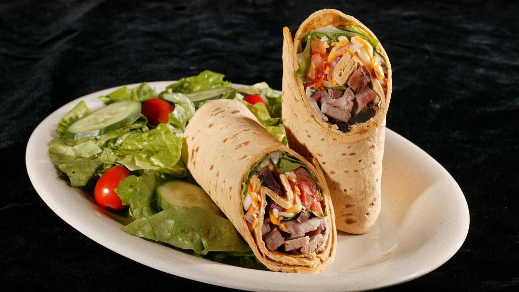 Southwest Wrap · Smoked turkey breast, Bar B Q pork or mesquite grilled chicken breast blended with corn, black beans, olives, red onion, tomatoes, cheddar jack cheese and chipotle sauce, perfectly packaged in a flour tortilla.