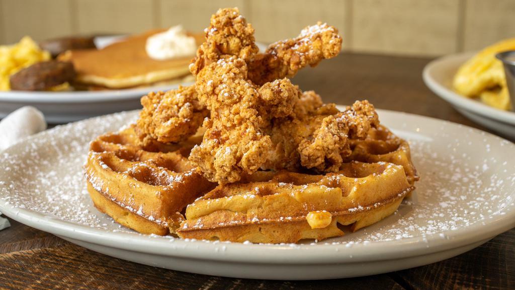 Chicken And Waffles · Salty and sweet with a little crunch. Our fresh, natural fried chicken strips served on a thick Belgian waffle, topped with fresh whipped butter and powdered sugar.