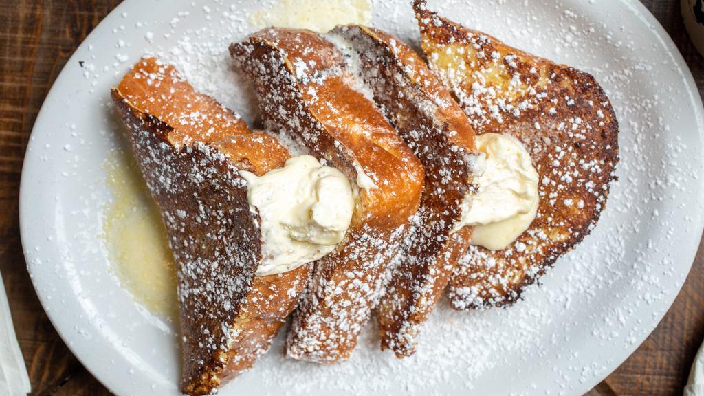 Original French Toast · Thick sliced homemade bread dredged in egg batter and lathered with our sweet whipped butter. Dusted with powdered sugar.