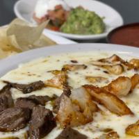 Mexicali Dip · Selection of grilled steak, chicken and shrimp, with queso dip, served with tortillas.