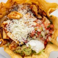 Taco Salad · Large crispy flour tortilla shell with cheese sauce, filled with shredded chicken or ground ...